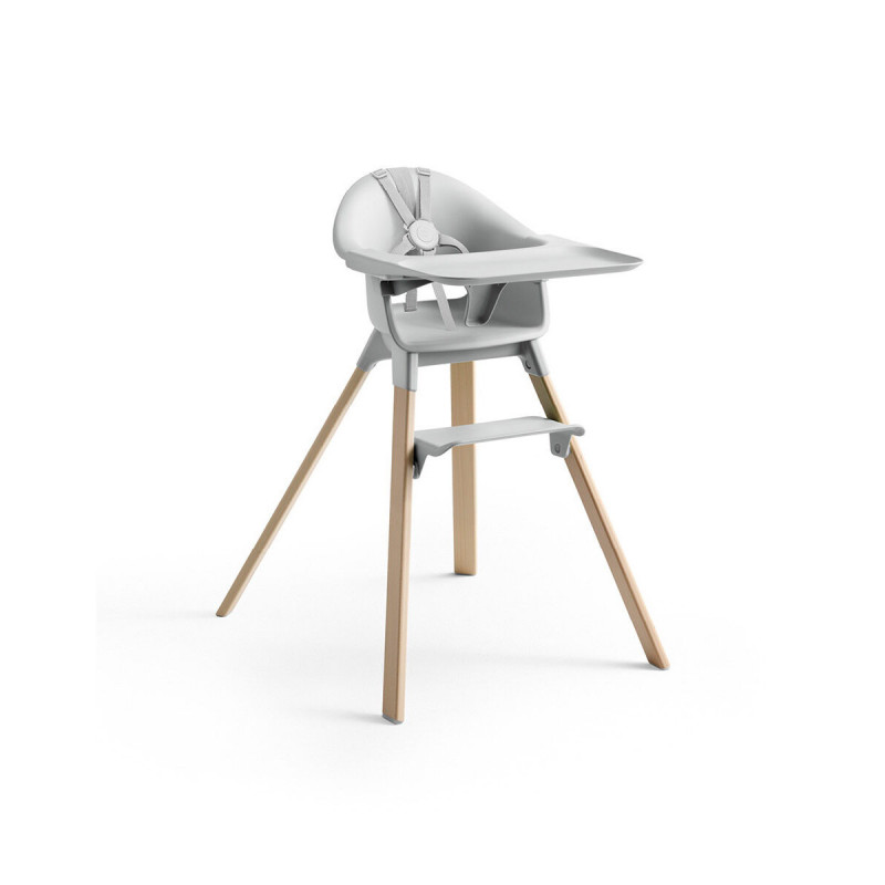 Trona Clikk de Stokke en color gris y patas de madera de haya. Incluye bandeja y arnés.